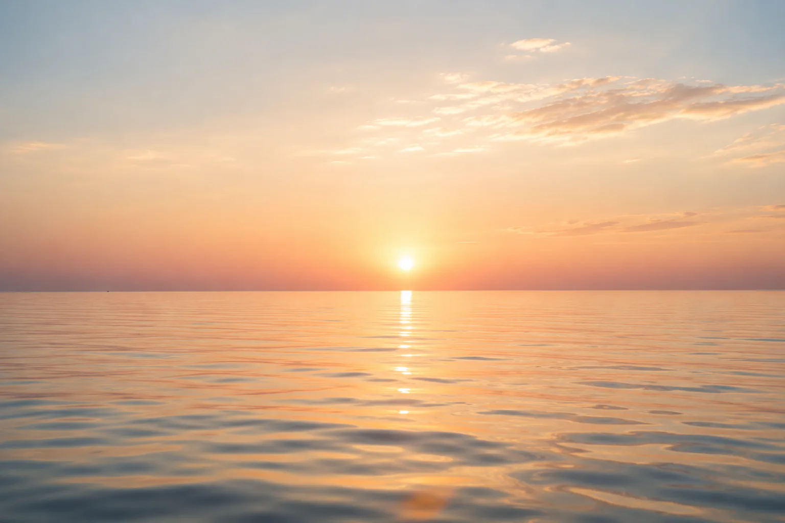 The sun setting over calm water